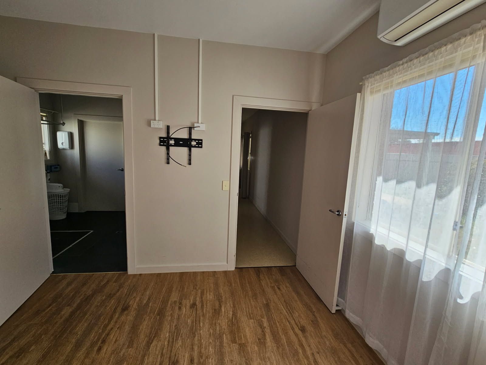 bedroom view to shared bathroom and hallway