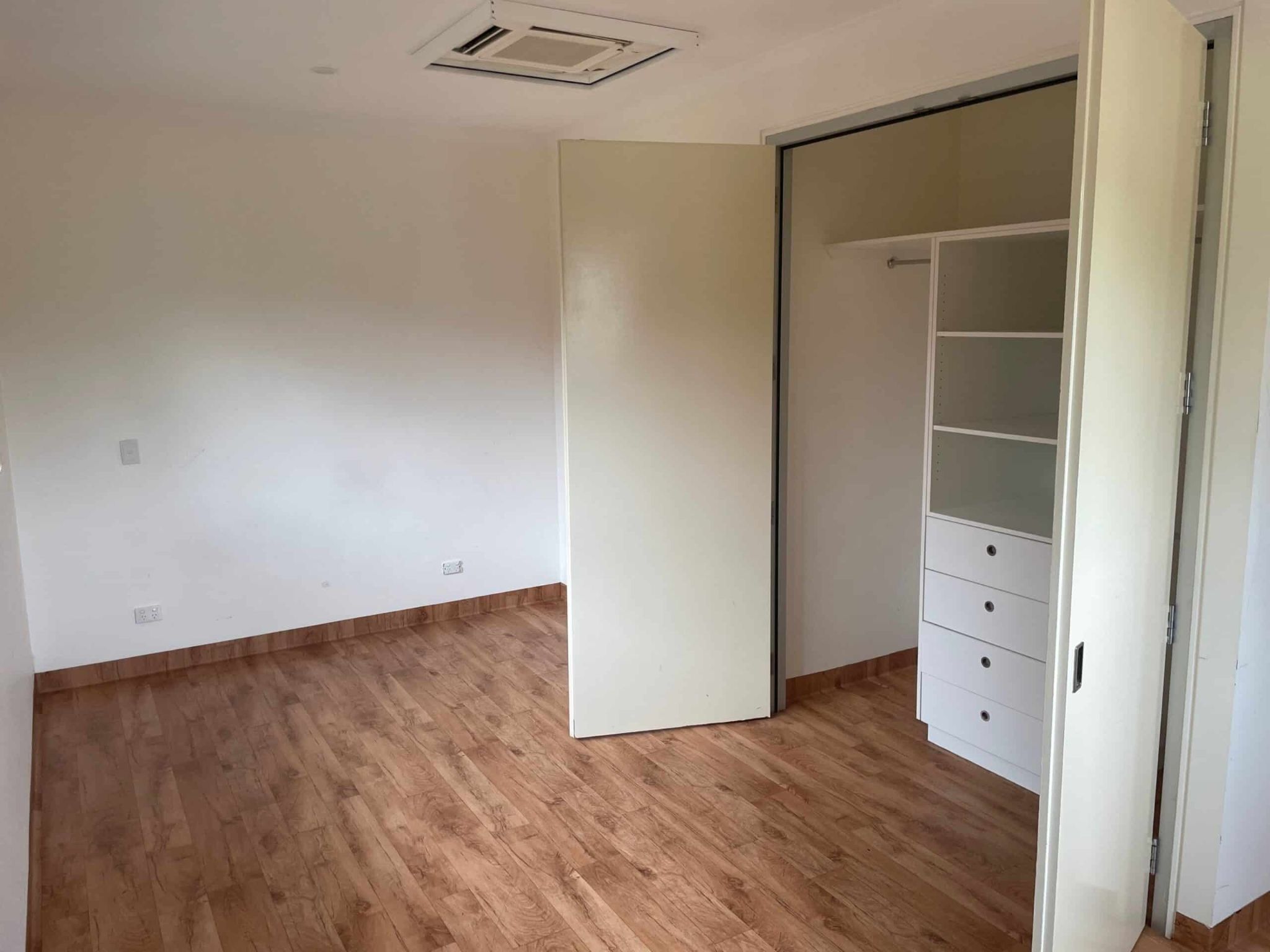 Unit bedroom-with-closet-space-and-wooden-floorboards