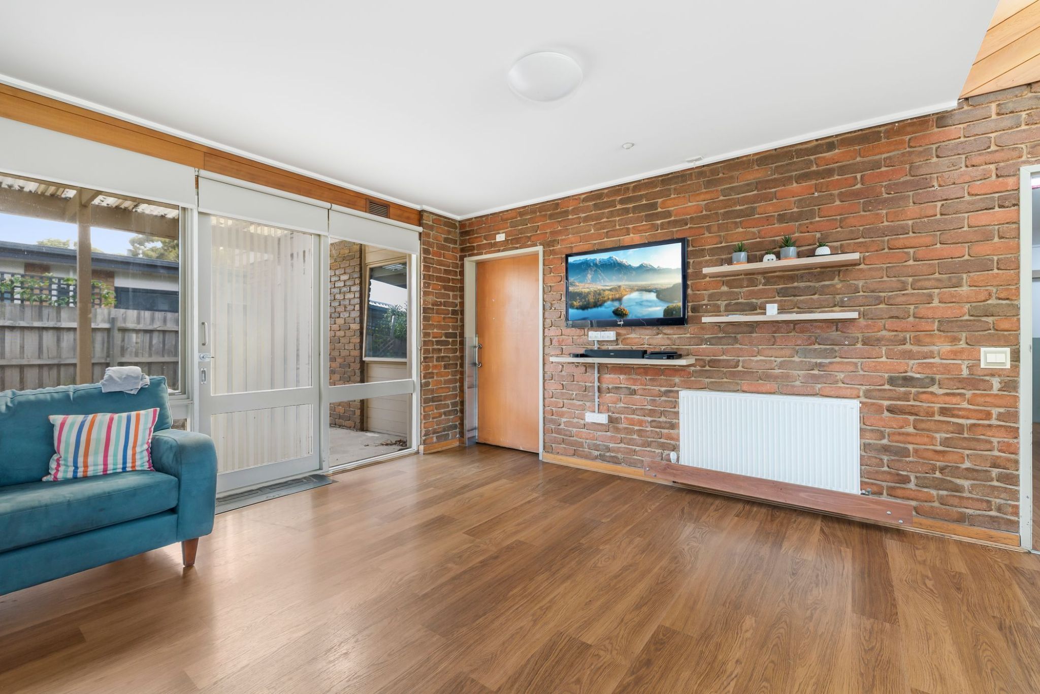 Living room with a TV and blue couch