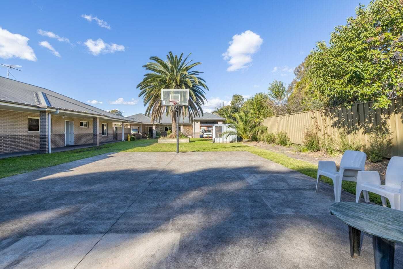 Backyard basketball-with-hoop_-palm-tree-and-outdoor-seating