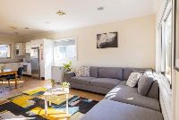 Shot of-the-living-room-with-view-of-the-kitchen-and-window-outside