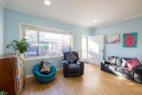 Unit 2s-living-room-with-multiple-seating-options-and-colourful-pillows-and-wallart