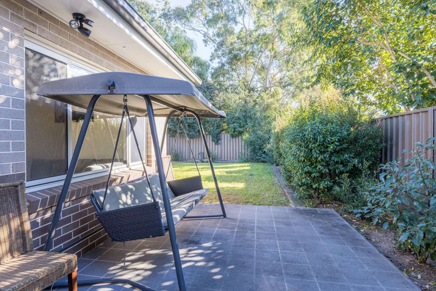 Backyeard space-of-unit-with-swing-seat-and-view-of-the-backyard-grass-area