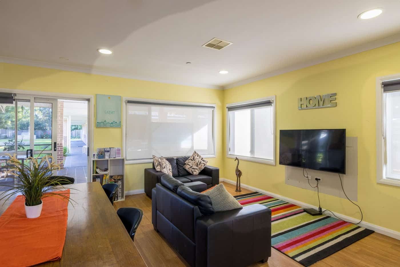 Common living-room-space-with-tv_-couches_-indoor-plants-and-view-of-the-backyard