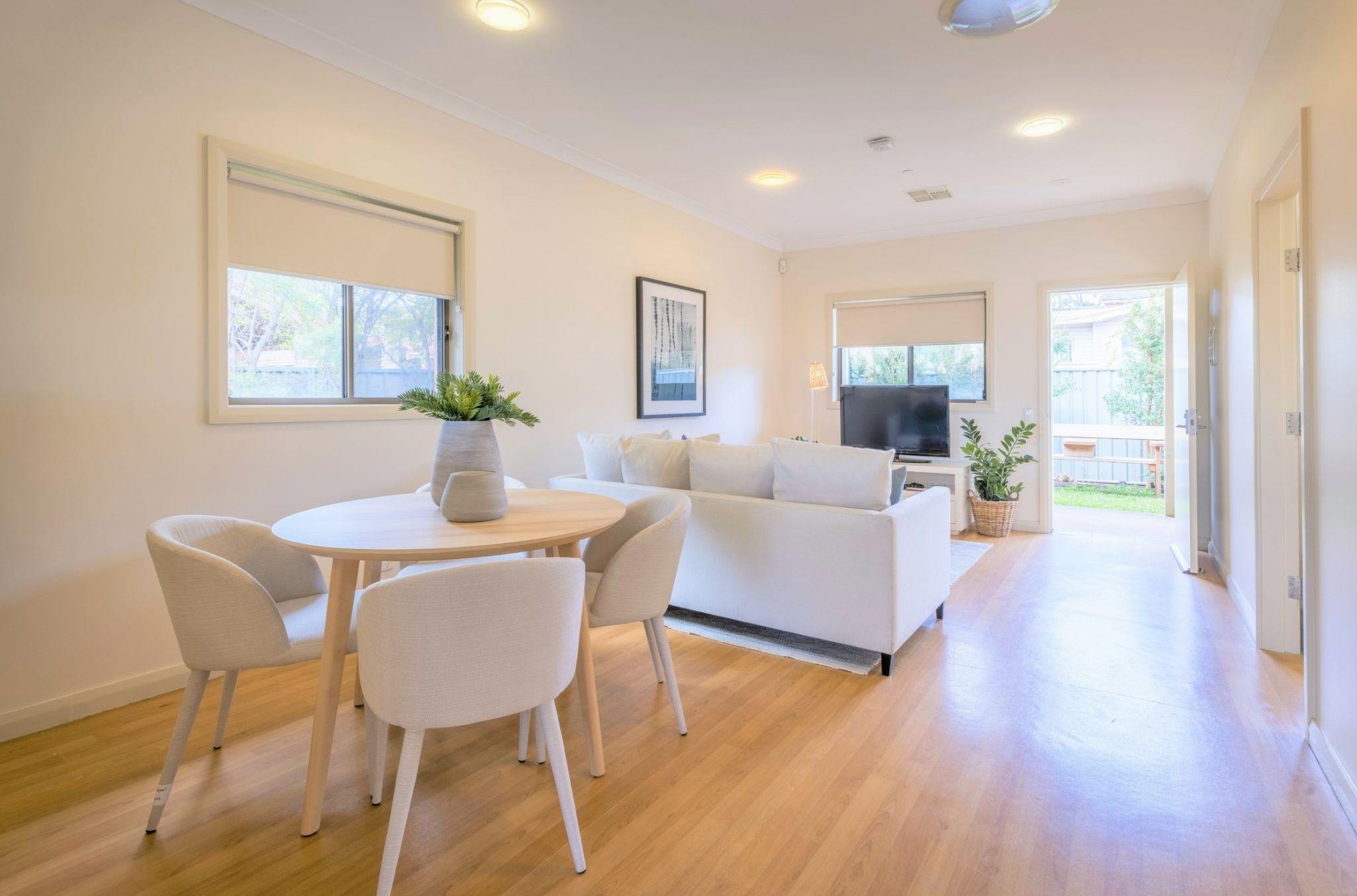 Modern living-room-dining-area-with-floorboards_-couch_-tv-and-dining-table