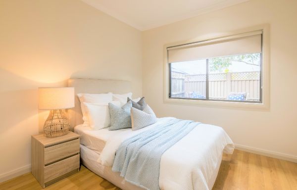Bedroom with-double-sized-bed_-side-table-and-window-to-the-backyard