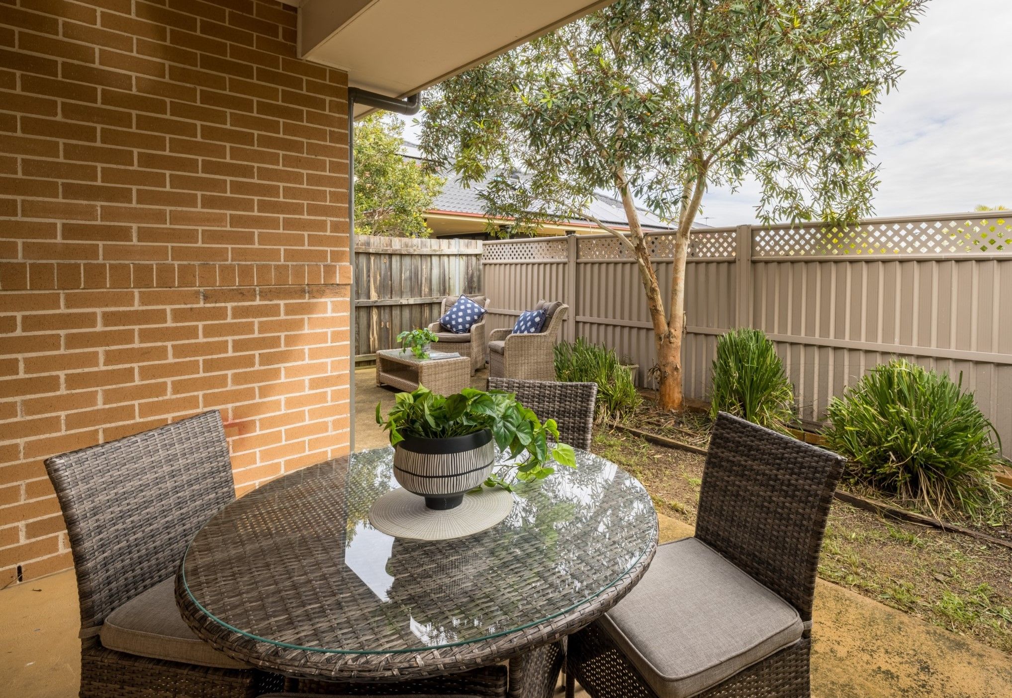 Courtyard of-home-with-multiple-seating-arrangements-and-plants