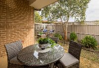 Courtyard of-home-with-multiple-seating-arrangements-and-plants